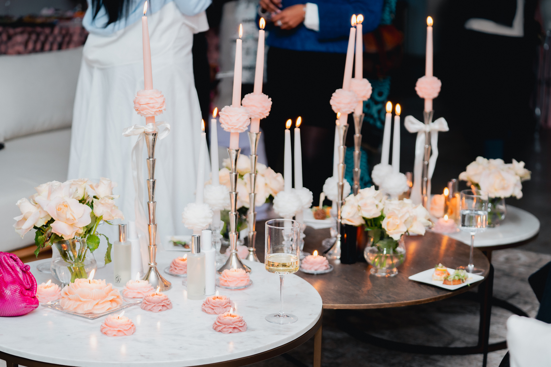 CandleBlooms peony tapers and blooms arranged on a candlelit gathering table with flowers and champagne